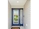 Stylish blue front door with glass panels and a digital lock system at 3500 Countryside Path, The Villages, FL 32163