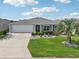 Charming home with a well-manicured lawn, mature landscaping, and a two-car garage at 3500 Countryside Path, The Villages, FL 32163