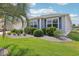 Landscaped front yard with manicured lawn, shrubbery, and decorative rock border at 3500 Countryside Path, The Villages, FL 32163