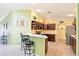 Cozy kitchen with breakfast bar, wood cabinets, and stainless steel refrigerator at 3500 Countryside Path, The Villages, FL 32163
