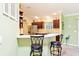 Modern kitchen with stainless steel appliances, a breakfast bar, and ample counter space at 3500 Countryside Path, The Villages, FL 32163