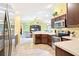 Open kitchen flows into the living room, stainless steel appliances, and white countertops at 3500 Countryside Path, The Villages, FL 32163