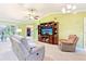 Spacious living room with a ceiling fan, plush seating, and entertainment center at 3500 Countryside Path, The Villages, FL 32163