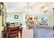 Bright living space seamlessly connected to the dining area and a glimpse of the kitchen at 3500 Countryside Path, The Villages, FL 32163
