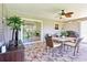 Covered patio with tiled flooring, a dining table and chairs, and a ceiling fan at 3500 Countryside Path, The Villages, FL 32163