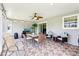 A delightful sunroom is furnished with seating, a dining table, and decorative lighting at 3500 Countryside Path, The Villages, FL 32163