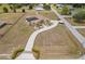 Expansive home featuring a screened pool, a long driveway and mature landscaping at 4725 County Road 121D, Wildwood, FL 34785
