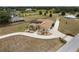 Gorgeous aerial view showcasing the home's landscaped circular driveway at 4725 County Road 121D, Wildwood, FL 34785