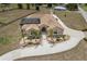Expansive home featuring a screened pool, a long driveway and lush landscaping at 4725 County Road 121D, Wildwood, FL 34785