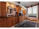 This bathroom has a vanity, black countertop, and a window with patterned glass at 4725 County Road 121D, Wildwood, FL 34785