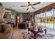 This bedroom boasts pool access, tile floors, and an eye-catching chandelier fan at 4725 County Road 121D, Wildwood, FL 34785