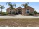 Lovely single story home featuring a long private driveway and lush landscaping at 4725 County Road 121D, Wildwood, FL 34785