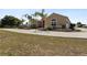Charming single-story home featuring a well-manicured lawn and a welcoming front entrance and a circular driveway at 4725 County Road 121D, Wildwood, FL 34785