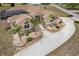 Inviting home featuring a manicured front yard, charming landscaping, and a welcoming entrance at 4725 County Road 121D, Wildwood, FL 34785