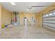 Spacious garage featuring high ceilings, storage space, and multiple access doors at 4725 County Road 121D, Wildwood, FL 34785
