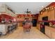 Spacious kitchen featuring tile floors, an island with seating and black appliances at 4725 County Road 121D, Wildwood, FL 34785