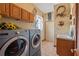 Laundry room featuring a washer, dryer, sink, cabinets and decor at 4725 County Road 121D, Wildwood, FL 34785