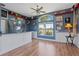 Living room with laminate flooring, bright lighting, fishing decor, and large windows at 4725 County Road 121D, Wildwood, FL 34785