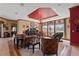 Elegant living room featuring decorative ceiling, chandelier, and ample natural light from large windows at 4725 County Road 121D, Wildwood, FL 34785