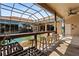 Outdoor pool bar with wood countertop, seating, and screened enclosure offering ample space for entertaining at 4725 County Road 121D, Wildwood, FL 34785