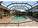 Large screened pool with waterfall, stone patio, and painted murals offers a relaxing outdoor experience at 4725 County Road 121D, Wildwood, FL 34785