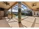 Stunning screened-in pool area features a waterfall, tiki bar and lush landscaping at 4725 County Road 121D, Wildwood, FL 34785