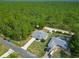 Spacious single-story home with a long driveway, storage shed and lush greenery at 5195 Sw 128Th Street Rd, Ocala, FL 34473