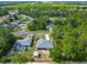 Aerial view of a single-Gathering home, detached garage and pool surrounded by lush landscaping at 5195 Sw 128Th Street Rd, Ocala, FL 34473