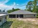 Wide backyard view with a utility shed to the left and a covered porch; great for relaxation and entertainment at 5195 Sw 128Th Street Rd, Ocala, FL 34473