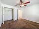 Carpeted bedroom with closet, fan and neutral walls for a comfortable feel at 5195 Sw 128Th Street Rd, Ocala, FL 34473