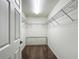 Walk-in closet featuring white walls and wire shelving to maximize storage in an organized and efficient space at 5195 Sw 128Th Street Rd, Ocala, FL 34473