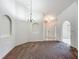 Open dining space shows archways, chandelier, and tile entryway at 5195 Sw 128Th Street Rd, Ocala, FL 34473