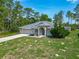 Charming single-Gathering home with an attached garage and a beautiful landscaped front yard at 5195 Sw 128Th Street Rd, Ocala, FL 34473