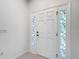 Bright foyer with a white front door featuring decorative glass panels at 5195 Sw 128Th Street Rd, Ocala, FL 34473