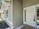 A white front door with decorative glass panels and a tiled entrance at 5195 Sw 128Th Street Rd, Ocala, FL 34473