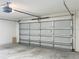 Spacious garage interior featuring an insulated garage door and concrete flooring, perfect for parking and storage at 5195 Sw 128Th Street Rd, Ocala, FL 34473