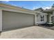 Attached garage with a concrete driveway and a manicured front yard at 5195 Sw 128Th Street Rd, Ocala, FL 34473