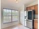 Bright kitchen nook area with a window and stainless steel refrigerator at 5195 Sw 128Th Street Rd, Ocala, FL 34473