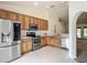 Well-lit kitchen features stainless steel appliances, tile flooring, and wooden cabinets at 5195 Sw 128Th Street Rd, Ocala, FL 34473
