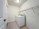 Functional laundry room with modern white appliances and neutral tile flooring, offering convenience and style at 5195 Sw 128Th Street Rd, Ocala, FL 34473