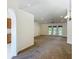 Spacious living room with plush carpeting and recessed lighting, leading to outdoor patio doors at 5195 Sw 128Th Street Rd, Ocala, FL 34473