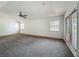 Spacious main bedroom featuring two windows and a door with blinds at 5195 Sw 128Th Street Rd, Ocala, FL 34473