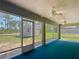 Cozy screened porch with ceiling fans, a glimpse of the backyard shed, and screened openings to the outside at 5195 Sw 128Th Street Rd, Ocala, FL 34473