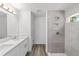 Modern bathroom featuring double sinks, quartz counters, and a tiled shower at 5389 Nw 65Th St, Ocala, FL 34482