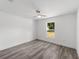 Bedroom features sleek flooring, neutral paint, and a window letting in natural light at 5389 Nw 65Th St, Ocala, FL 34482