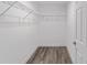 Walk-in closet features wood-look flooring and wire shelving for storage at 5389 Nw 65Th St, Ocala, FL 34482