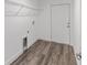 Laundry room features wood-look flooring, a utility sink, and wire shelving at 5389 Nw 65Th St, Ocala, FL 34482