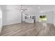 Open-concept living space with wood-look floors, seamlessly connecting to the kitchen at 5389 Nw 65Th St, Ocala, FL 34482