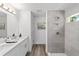 Modern main bathroom with a double-sink vanity and a beautifully tiled walk-in shower at 5389 Nw 65Th St, Ocala, FL 34482