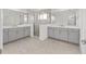 A bathroom features double vanity sinks, a glass enclosed shower, and tile floors at 5894 Sw 77Th Ct, Ocala, FL 34481